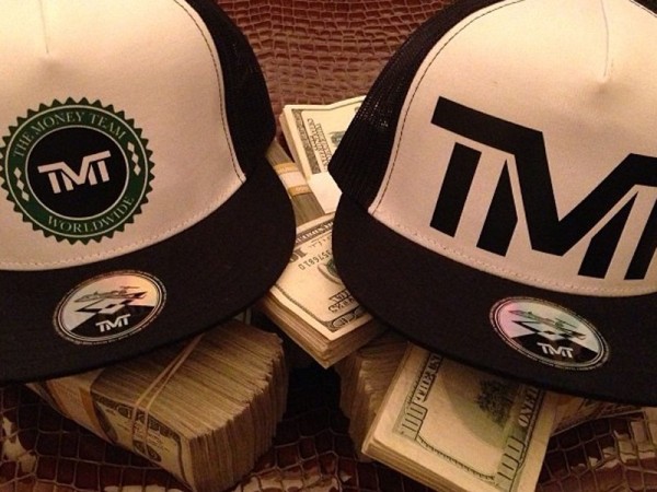 he-promoted-his-the-money-team-line-of-hats-by-putting-them-on-stacks-of-10000-in-cash