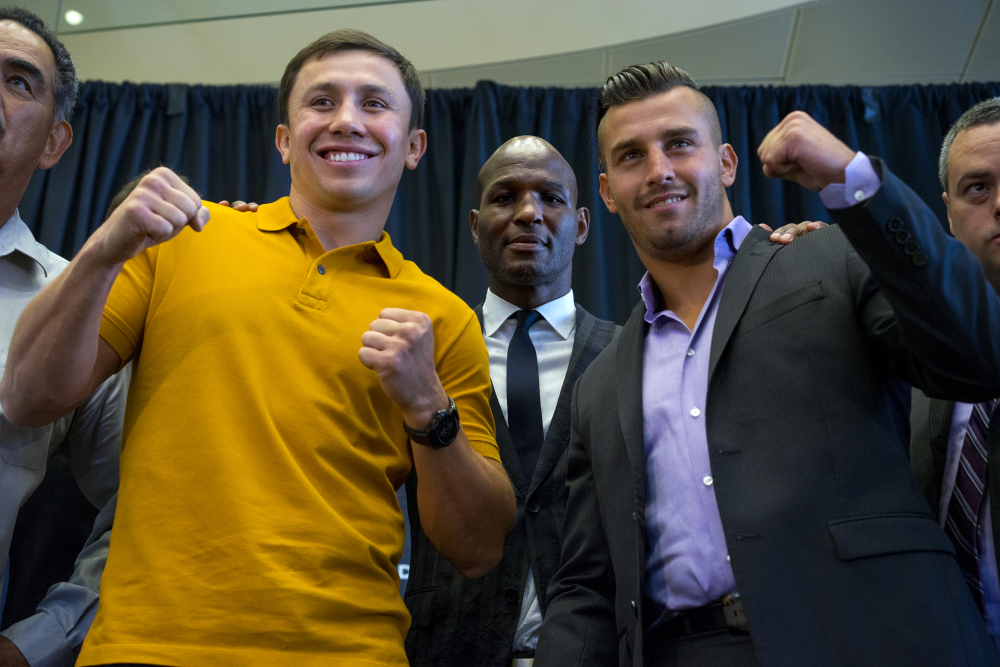 Middleweight boxers Gennady Golovkin, left, of Kazakhstan, and David Lemieux, of Canada, pose together during a news conference Tuesday, Aug. 18, 2015, in New York, to promote their middleweight world championship title unification bout set for Saturday, Oct. 17, 2015, at Madison Square Garden. At rear center is boxer Bernard Hopkins. (AP Photo/Craig Ruttle) ORG XMIT: NYCR101